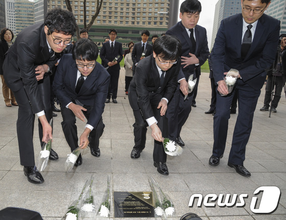 首尔市政府职员在纪念碑前献花悼念遇难人员(图片来源:news1新闻)