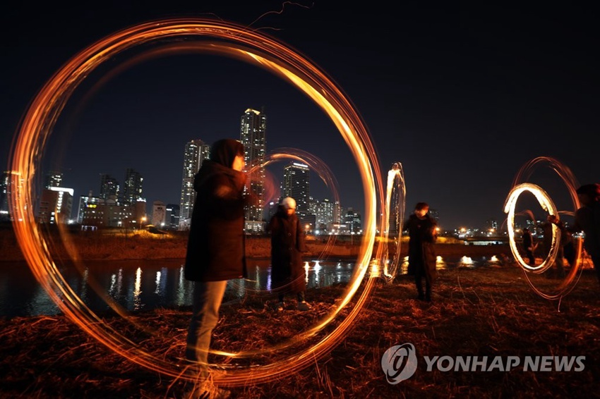 在首爾安養川邊，首爾市民進行鼠火游戲。圖片來源：韓聯社