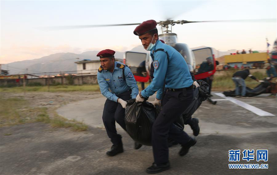 10月14日，在尼泊爾加德滿都，人們運送遇難者遺體。