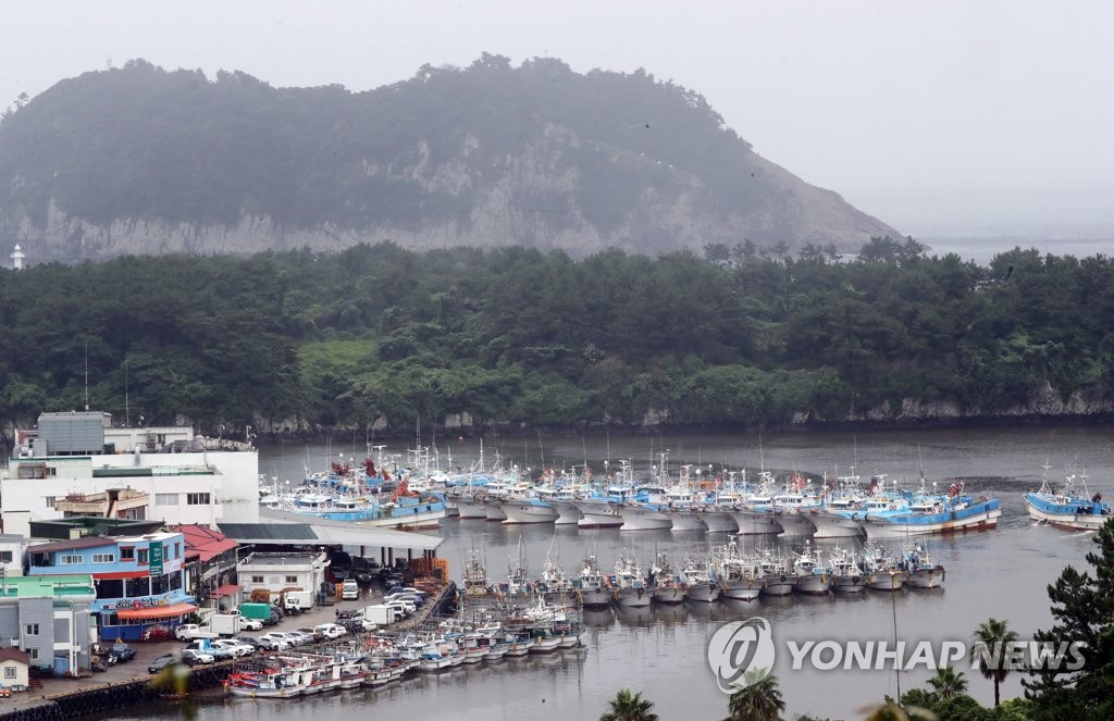 第5号台风“丹娜丝”北上即将登陆韩国。18日下午，渔船在济州道西归浦港躲避。