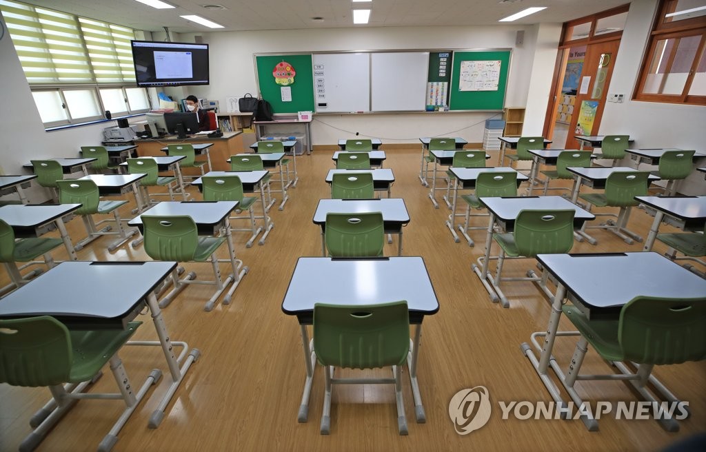 316日上午，一名教師正在首爾新東小學空無一人的教室內進行雙向在線授課。
