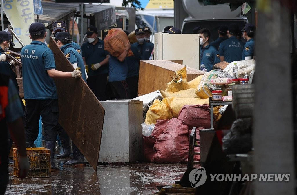 韓國慶尚南道地區遭遇強降水。當地警察出動，前來支援受災嚴重的花開市場。