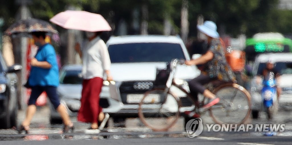 8月17日下午，在大邱市壽城區，天氣炎熱，市民做好防晒措施出門。