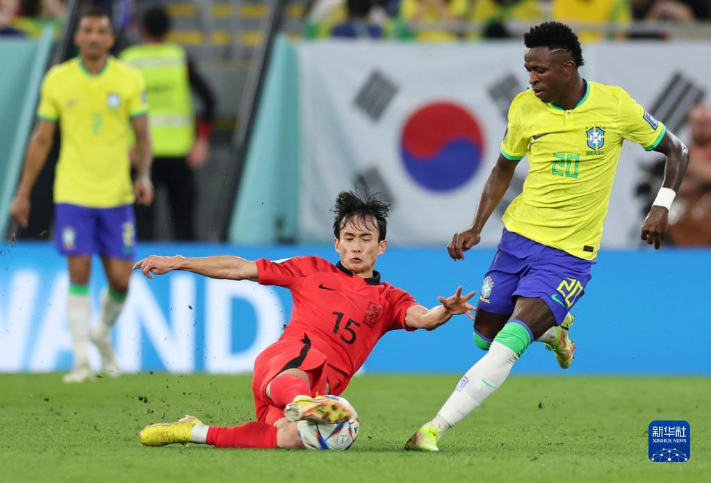 12月5日，巴西隊球員維尼修斯（右）與韓國隊球員金紋奐在比賽中拼搶。新華社記者 徐子鑒 攝