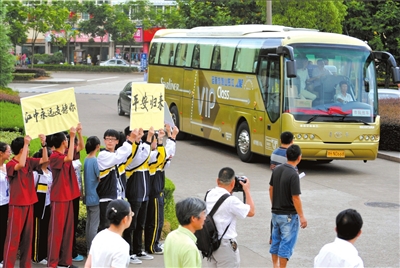韩亚空难飞行员回国受调查 江山市邀律师指导索赔图为14日，江山中学师生和家长在校门口迎接载着31名该校师生的大巴。（图片来源 新华社）